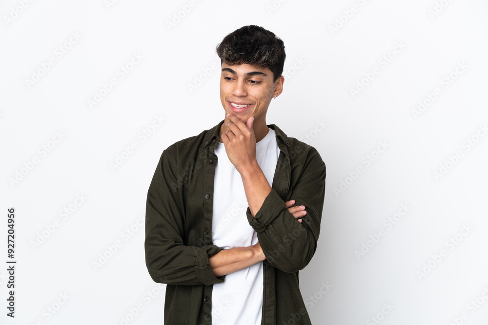 Young man over isolated white background looking to the side and smiling Young man over isolated white background looking to the side and smiling