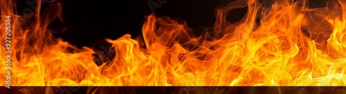 Horizontal banner of fire flames on a black background with ample copy space for text, showcasing abstract textures of orange and yellow flames, ideal for hot energy concepts.