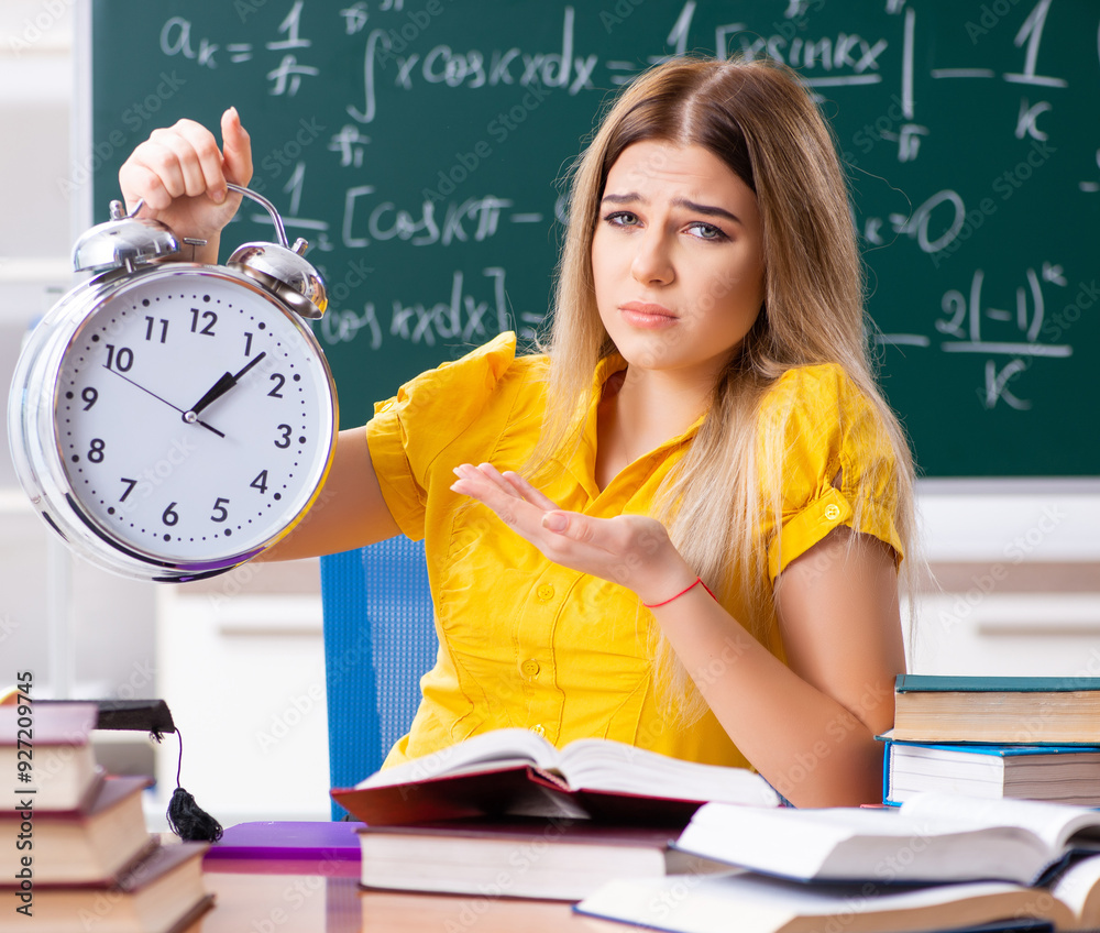 Young female student in front of the chalkboard
