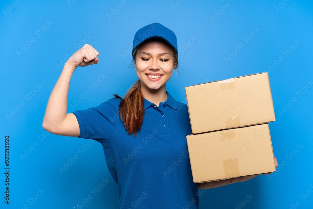 Delivery girl over isolated blue wall doing strong gesture Delivery girl over isolated blue wall doing strong gesture