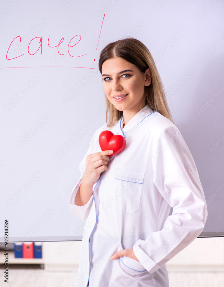 Young female doctor standing in front of the white board Young female doctor standing in front of the white board