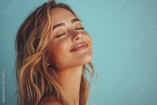 A close up of a woman's face with her eyes closed and long blond hair