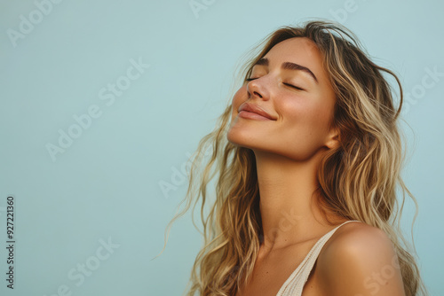 A close up of a woman's face with her eyes closed and long blond hair