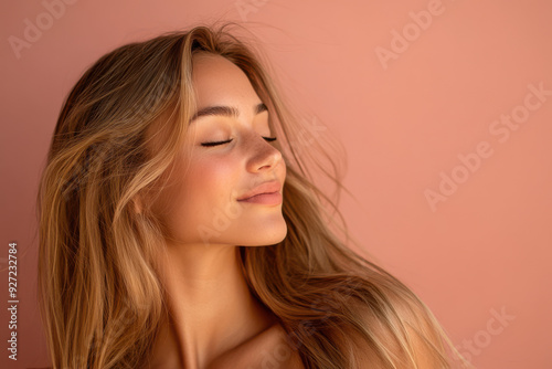 A close up of a woman's face with her eyes closed and long blond hair