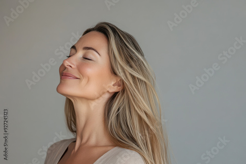 A close up of a woman's face with her eyes closed and long blond hair