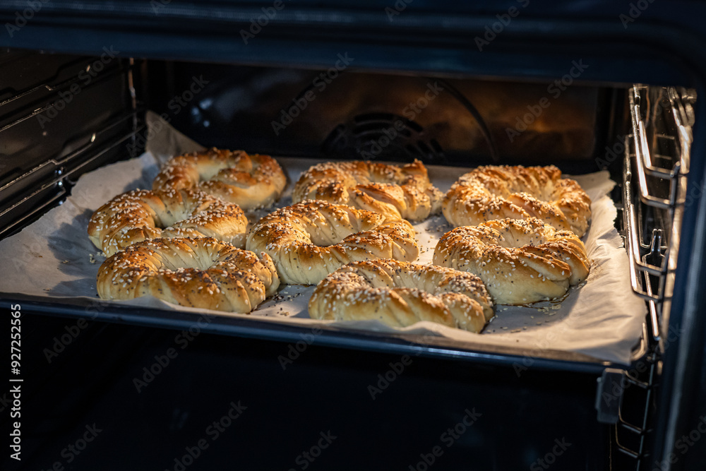 Freshly baked homemade bagels with poppy and sesame seeds. The process of baking dough in oven.
Freshly baked homemade bagels with poppy and sesame seeds. The process of baking dough in oven.