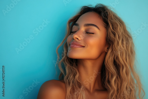A close up of a woman's face with her eyes closed and long blond hair