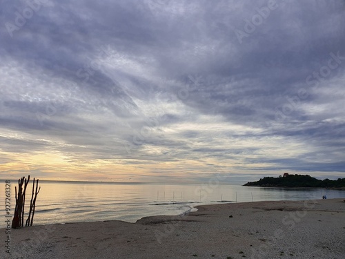 The sea in the morning during the monsoon season is covered with rain clouds that are ready to fall at any moment.
