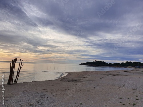 The sea in the morning during the monsoon season is covered with rain clouds that are ready to fall at any moment.

