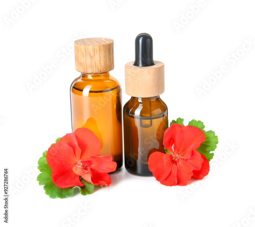 Bottles of geranium essential oil and beautiful flowers isolated on white