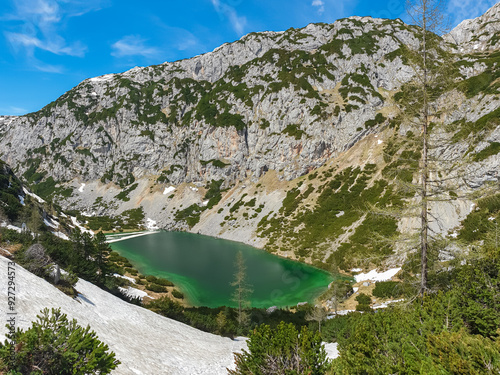 Aerial view of serene alpine lake Hölltalsee (Silberkarsee) surrounded by majestic snow-capped landscape in Schladming, Styria, Austria. Hiking trail in Austrian Alps in spring. Schladminger Tauern photo