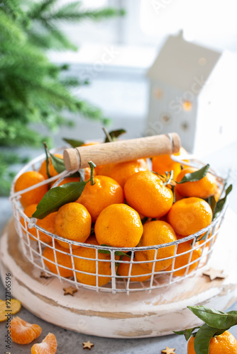 Tangerines in a basket in Christmas decor, selective focus