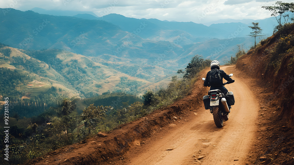 A motorbike speeding along a narrow dirt trail in the mountains, with the landscape stretching out below.
A motorbike speeding along a narrow dirt trail in the mountains, with the landscape stretching out below.