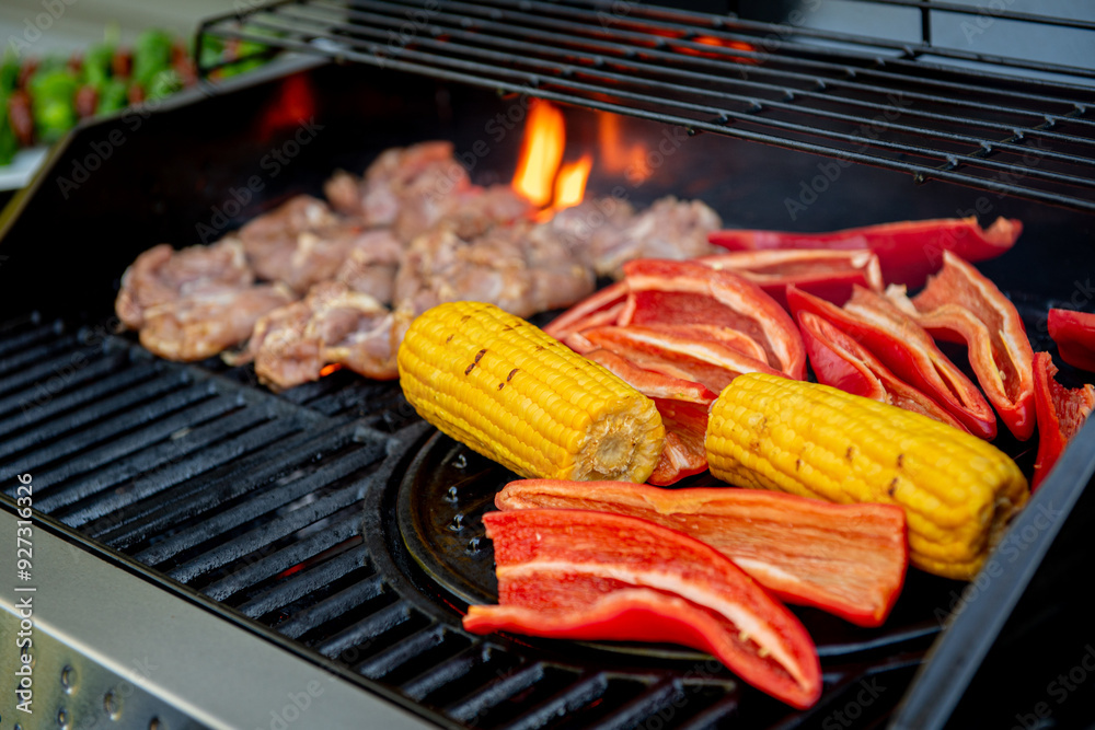 Grilled chicken meat with vegetables on barbecue grill with smoke. Grilled chicken meat with vegetables on barbecue grill with smoke.