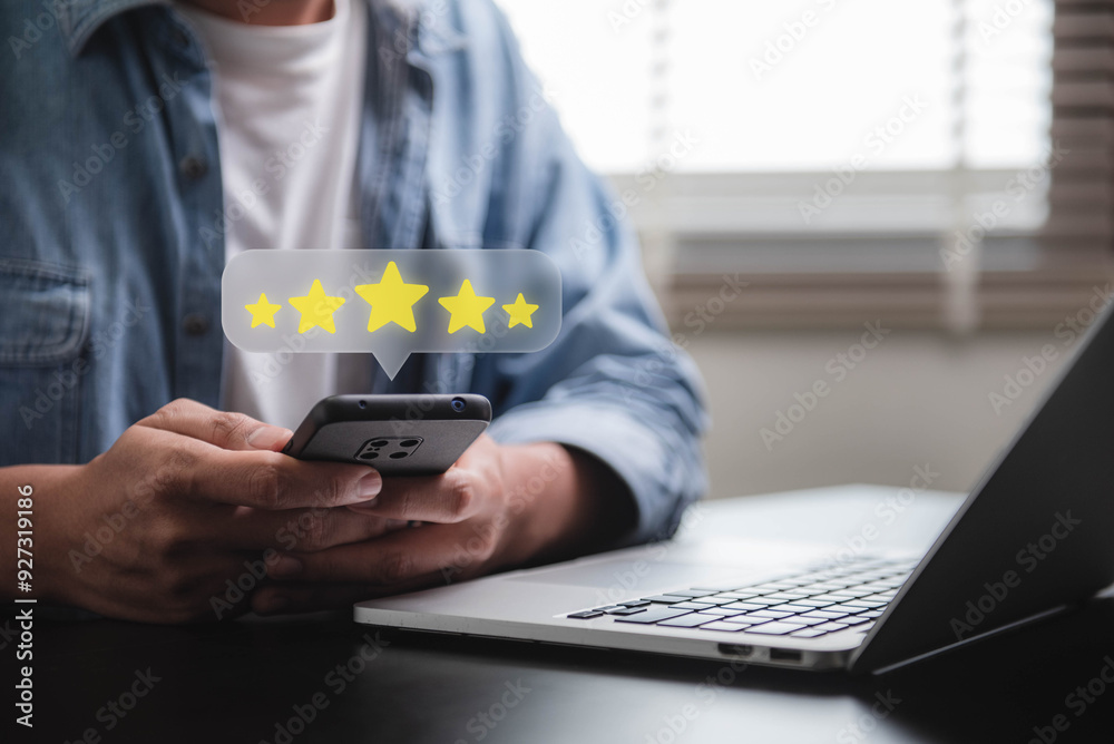 © IDOL'foto - Customer review good rating feedback concept, A person using a smartphone to leave a 5-star review, with emphasizing online feedback. testimonial and testimony, user comment and feedback for review.
