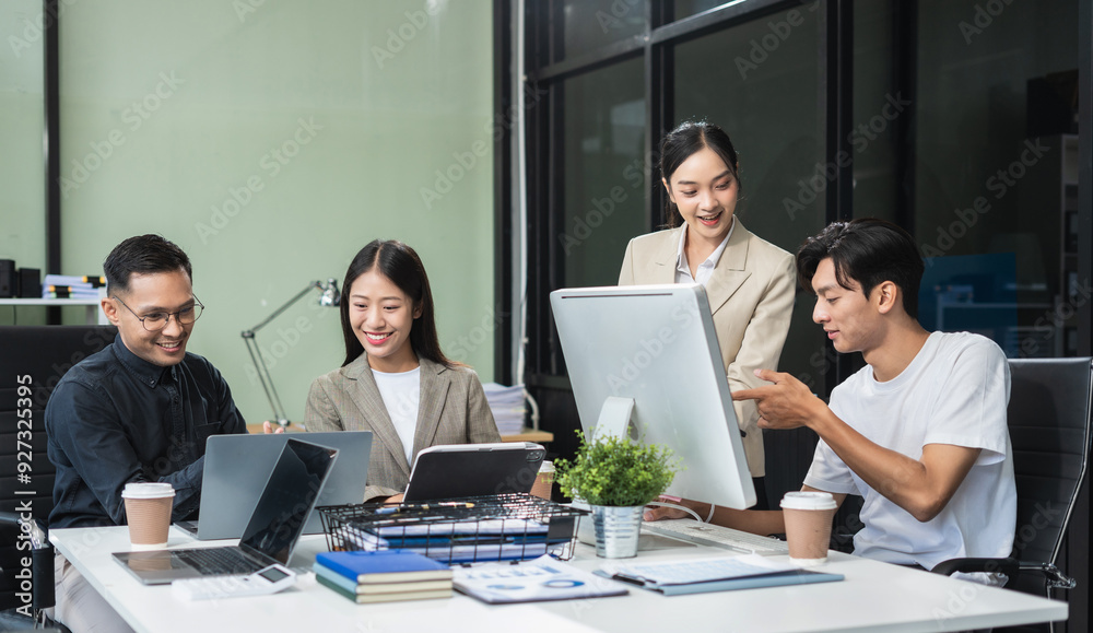 Business team working on a project in the office or reviewing and discussing a business project. Business team working on a project in the office or reviewing and discussing a business project.