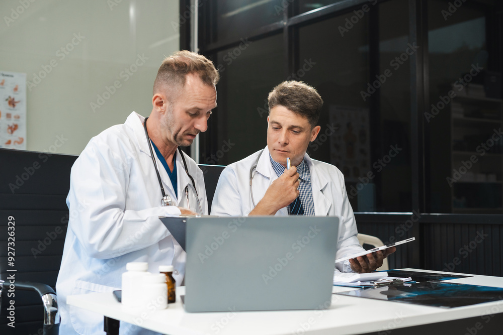 Medical team working on digital tablet healthcare doctor technology tablet using x-ray film analyzed the results of medical reports. Medical team working on digital tablet healthcare doctor technology tablet using x-ray film analyzed the results of medical reports.