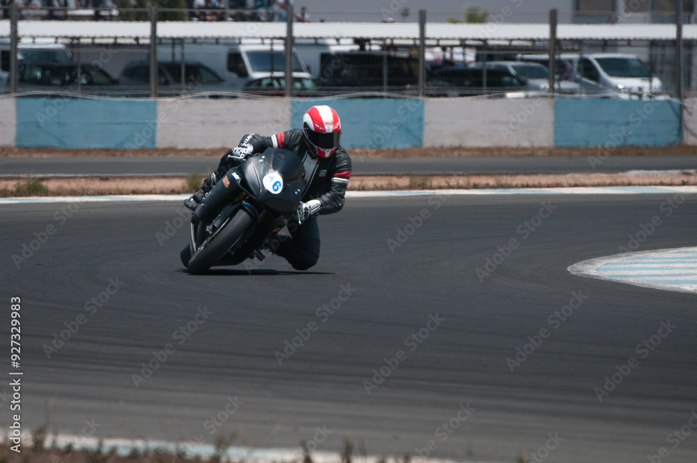 Unrecognized Biker in Helmet and Leather Jacket Speeds in a motor racing track