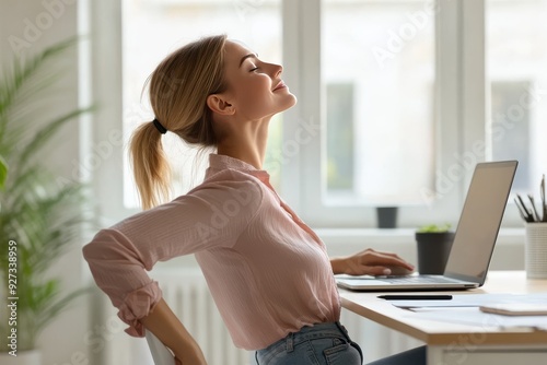 woman doing gentle neck and shoulder stretches while sitting at her desk in an office