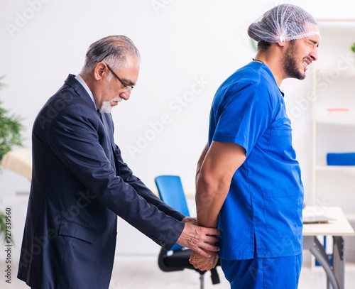 Male doctor in courthouse meeting with advocate