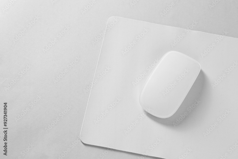 Wireless mouse and mousepad on white background, top view. Space for text Wireless mouse and mousepad on white background, top view. Space for text