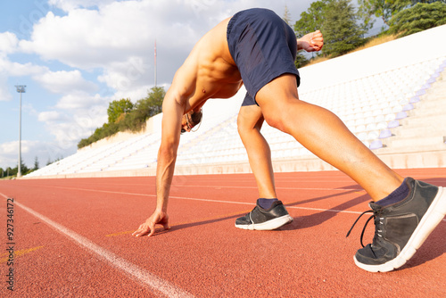 man athlete in a starting position looking determined and focused