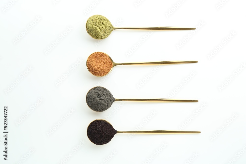 Spoons with different superfood powders on white background, flat lay Spoons with different superfood powders on white background, flat lay