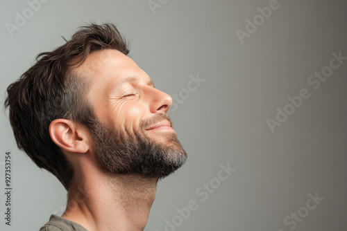 A close up of a man's face with her eyes closed