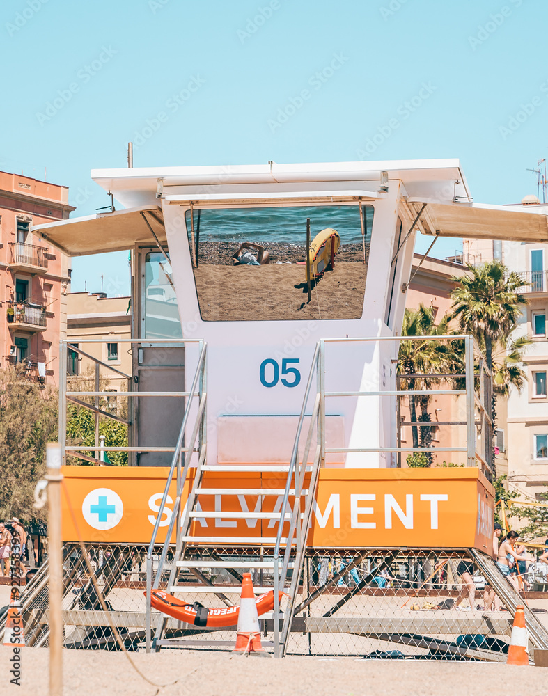 Reflection in the Beach Lifeguard Station in Barcelona with Blue Sky and Sunbather