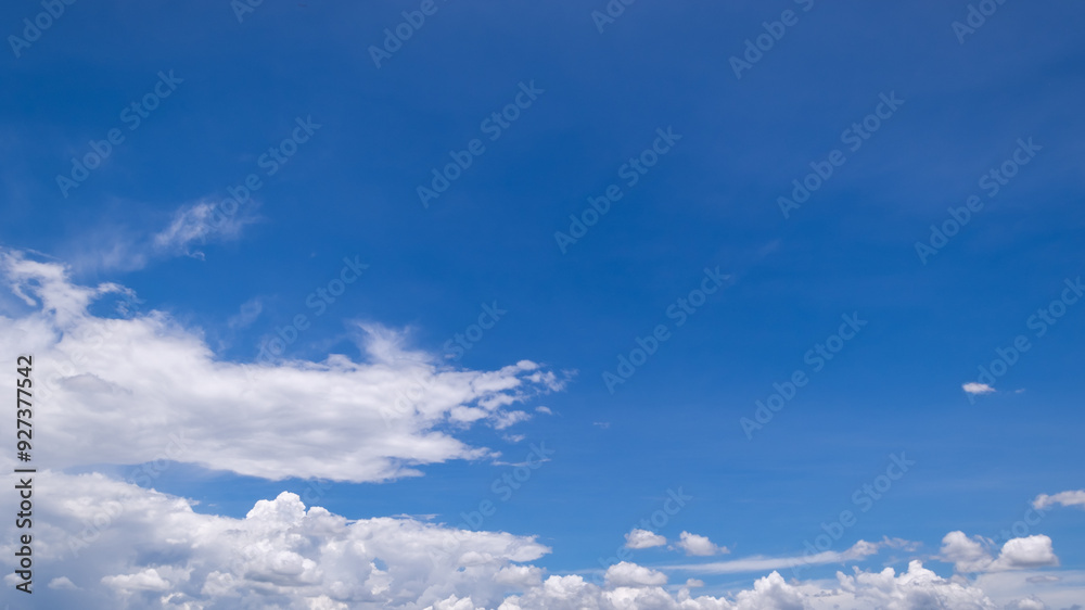 Obraz premium clear blue sky background,clouds with background, Blue sky background with tiny clouds. White fluffy clouds in the blue sky. 