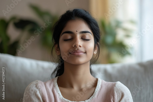 Indian Woman Practicing Meditation on a Couch: Relaxed Close-Up of Deep Breathing Yoga Exercise for Mental Well-Being in a Cozy Living Room Free Download Indian Woman Practicing Meditation on a Couch: Relaxed Close-Up of Deep Breathing Yoga Exercise for Mental Well-Being in a Cozy Living Room - GFXLoad