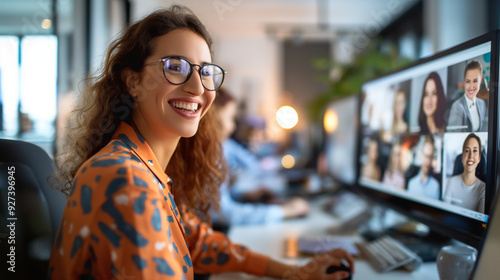 Smiling Woman Participating in Virtual Meeting at a Lively Modern Office