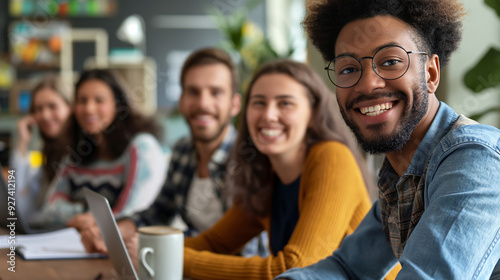 Diverse Group of Smiling Young Adults Collaborating in Creative Workspace