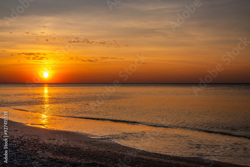 Sandy beach with pebbles of Baltic Sea on Curonian Spit at sunset. Kaliningrad region. Russia