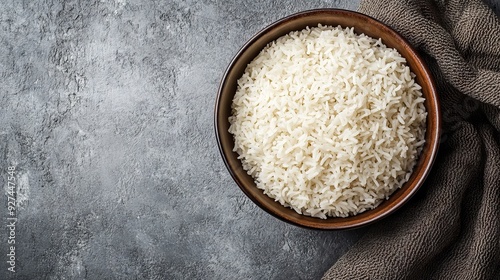 Bowl of tasty cooked rice on grey background, top view. Space for text --ar 16:9 --v 6.1 Job ID: b6d15d9d-efa9-4fcc-99a3-9d865371ddcd