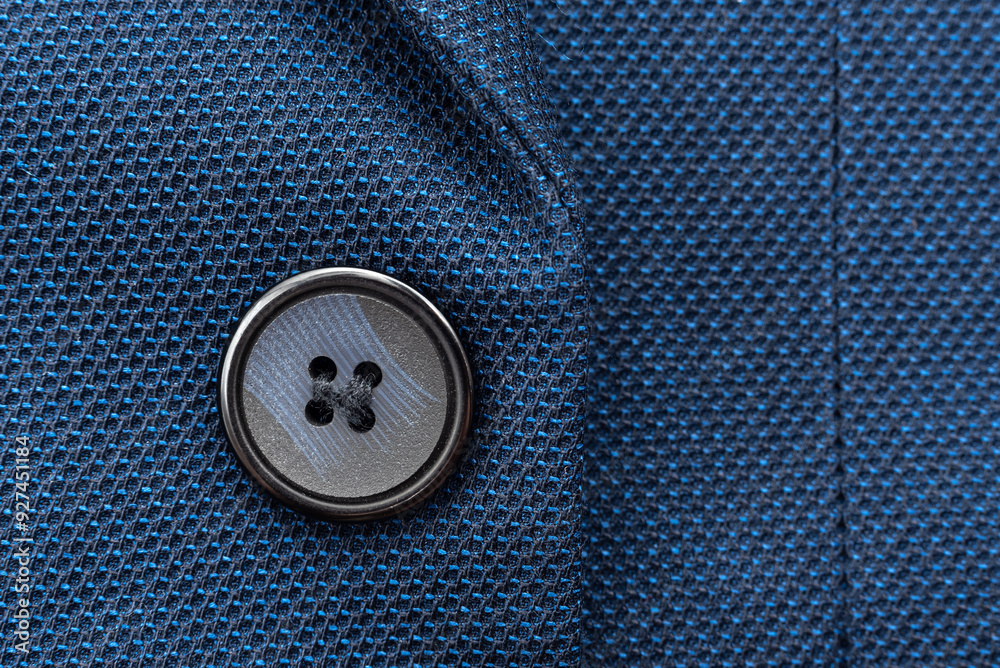 Close-up of a button on a men's blue suit. Button on a suit Close-up of a button on a men's blue suit. Button on a suit