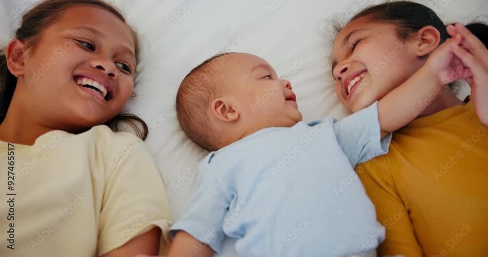 Children, love and sisters with their baby brother in the bedroom of their home together from above. Family, smile or happy with girl kids and an infant boy playing on a bed for morning bonding Children, love and sisters with their baby brother in the bedroom of their home together from above. Family, smile or happy with girl kids and an infant boy playing on a bed for morning bonding