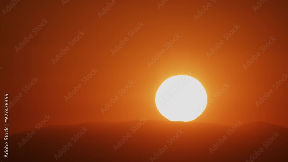 Zoom in to Extreme Closeup of Sun Rising Over a Hill into a Red Sky 4K Timelapse