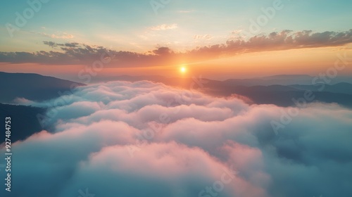 Majestic Sunrise Over Cloud-Covered Mountain Range