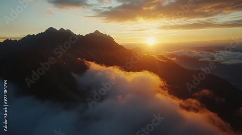 Majestic Sunrise Over Cloud-Covered Mountain Range