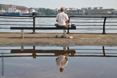 Solitary Man Reflecting by the Waterfront With Scenic Views to Meditation