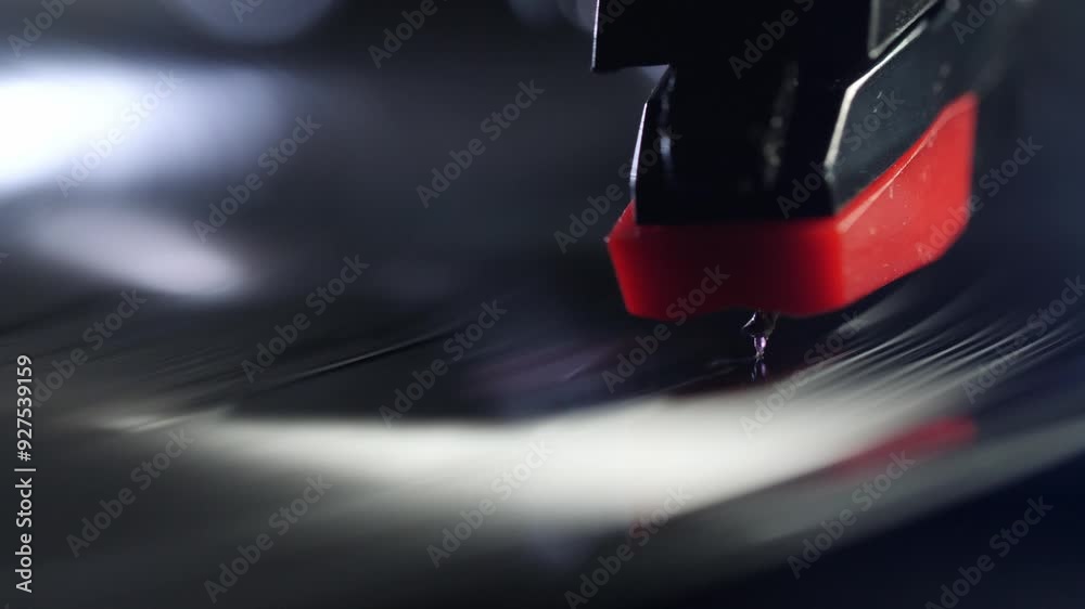 The turntable needle lands on the vinyl record, macro shot.