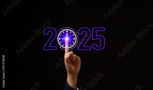 Obraz na płótnie Hand touching clock time to change from 2024 to 2025, the clock is ticking towards 2025, countdown of merry Christmas and happy new year, business planning and strategy future concept. w salonie