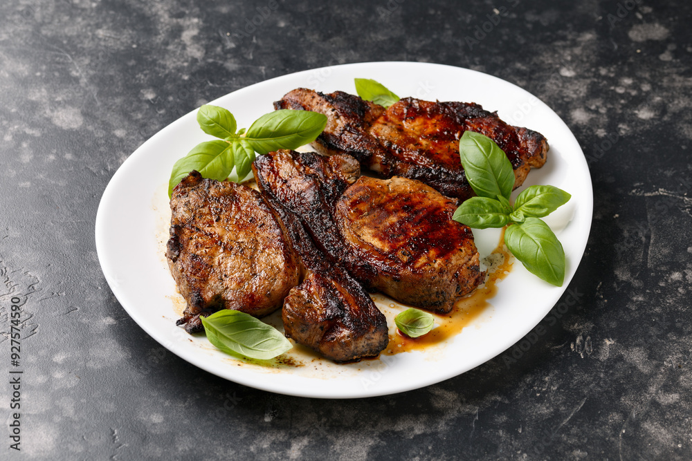 Grilled Pork Loin steaks in a white plate Grilled Pork Loin steaks in a white plate