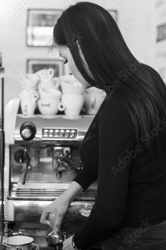 Woman making coffee in cafe