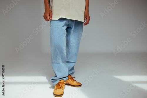 Obraz na płótnie Casual mens fashion showing modern light blue jeans design. The image highlights comfort and style of light denim in contemporary fashion for people. w salonie