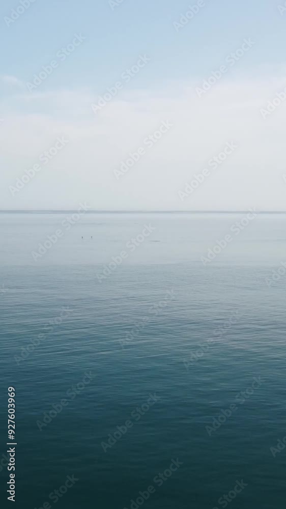 Vertical aerial view on sea water surface, camera flies over clear sea water. Sun glare. Abstract nautical summer ocean nature. Holiday, vacation and travel concept. Nobody. Weather and climate change Vertical aerial view on sea water surface, camera flies over clear sea water. Sun glare. Abstract nautical summer ocean nature. Holiday, vacation and travel concept. Nobody. Weather and climate change