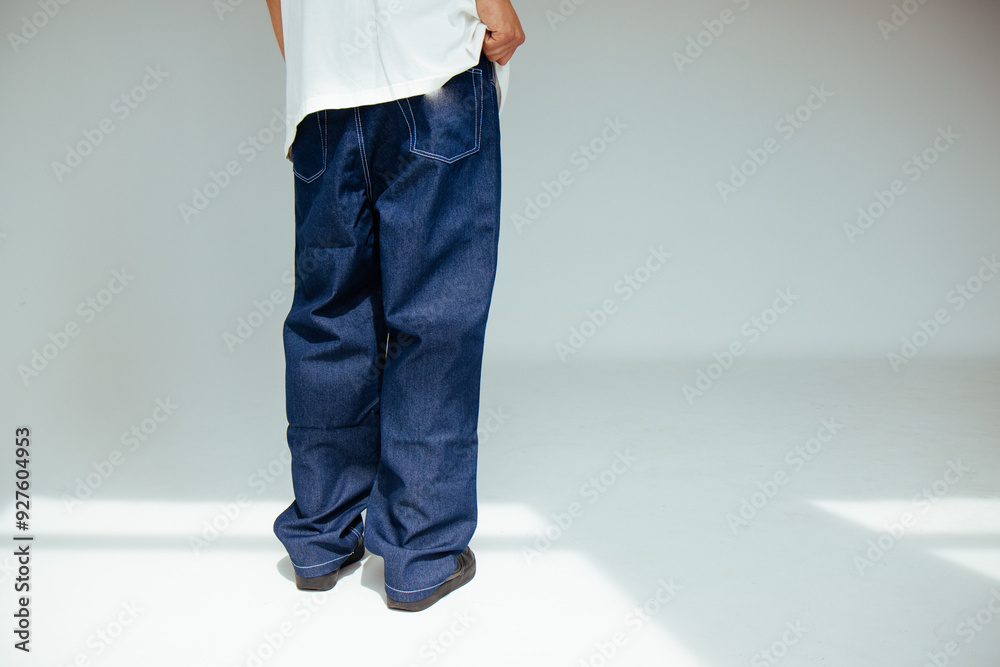 Fashion forward people concept with male model in well-fitted dark blue regular jeans. The design showcases comfort and style in everyday dark denim wear.