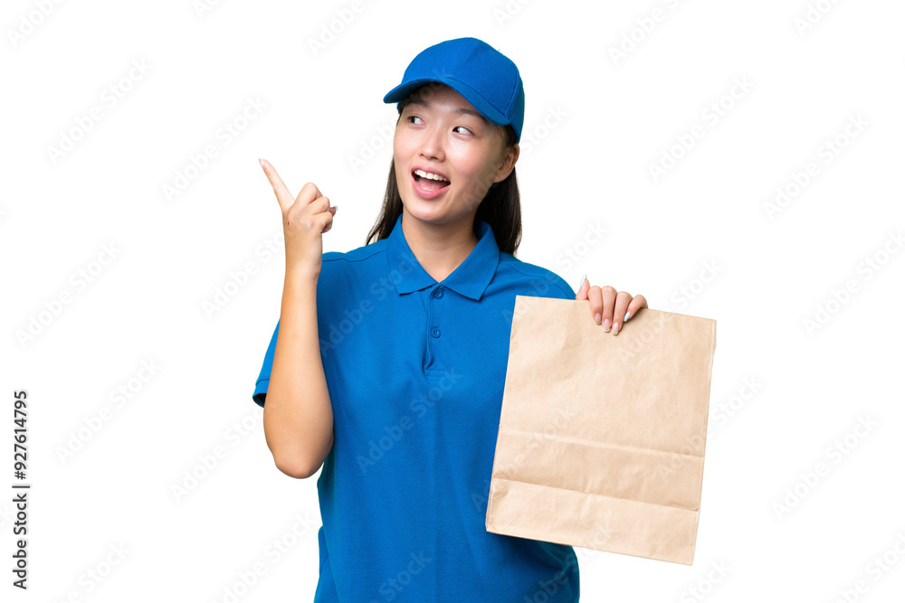 Young Asian woman taking a bag of takeaway food over isolated background intending to realizes the solution while lifting a finger up Young Asian woman taking a bag of takeaway food over isolated background intending to realizes the solution while lifting a finger up