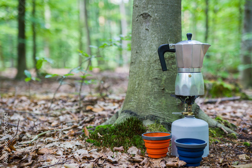 Picnic in the forest. Making coffee on a stump in the middle of a clearing.